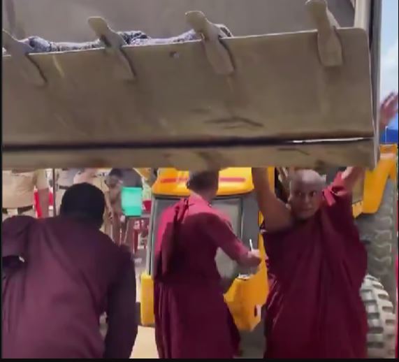 Buddhist monks forced to lie before bulldozers as statue demolished in Maharashtra